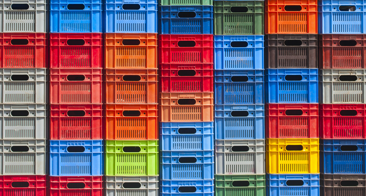 Coloured, plastic crates stacked on top of each other.